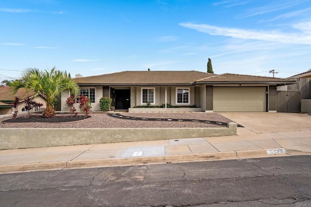 single story home featuring stucco siding, driveway, and a garage