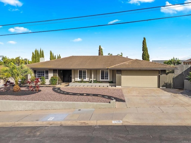 ranch-style home featuring fence, driveway, stucco siding, a garage, and a tile roof