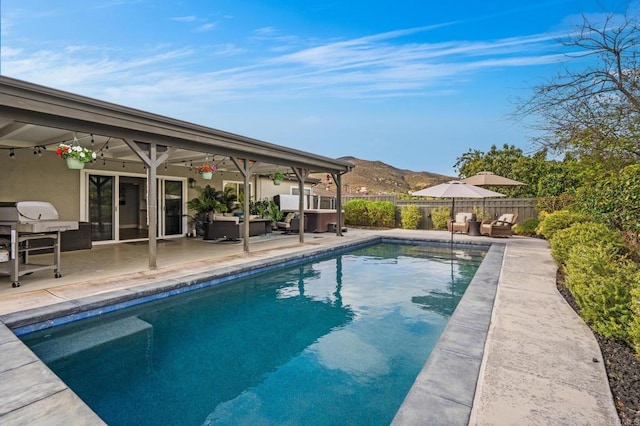 view of pool featuring a mountain view, a patio, a fenced in pool, and a fenced backyard