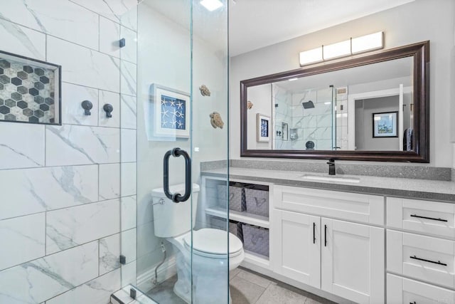 bathroom featuring toilet, a stall shower, and vanity