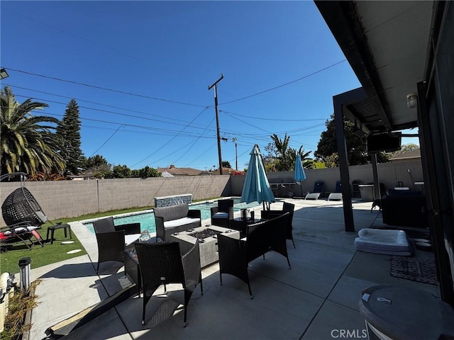 view of patio featuring a fire pit, a fenced in pool, and a fenced backyard