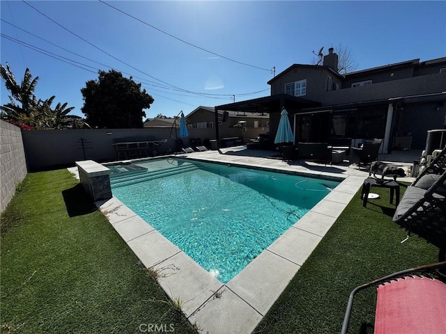 view of swimming pool with a patio, a fenced backyard, a fenced in pool, and a lawn