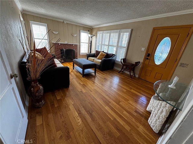 9410 S 4th Ave, Inglewood, CA 90305 - living room featuring wood finished floors, a textured ceiling, a brick fireplace, and ornamental molding
