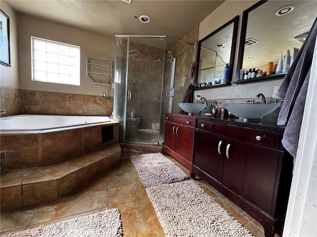 full bath with a bath, a stall shower, double vanity, and a sink