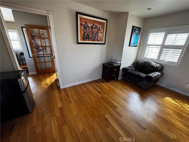 living area featuring wood finished floors and baseboards