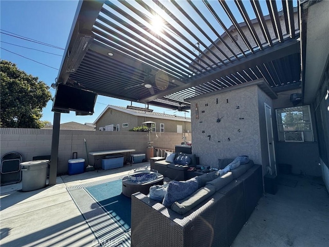 view of patio featuring an outdoor living space with a fire pit and fence