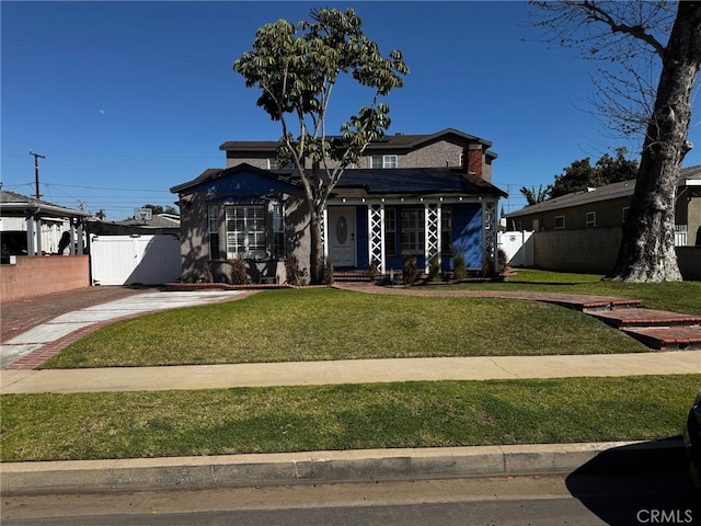 bungalow with a front lawn, a gate, fence, and roof mounted solar panels