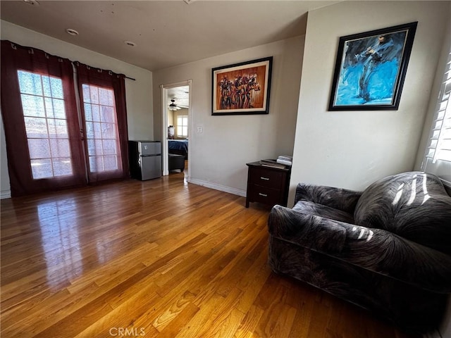 living room featuring baseboards and light wood finished floors