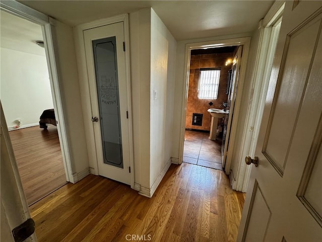9410 S 4th Ave, Inglewood, CA 90305 - corridor with baseboards and light wood-style flooring