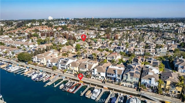 birds eye view of property with a water view and a residential view