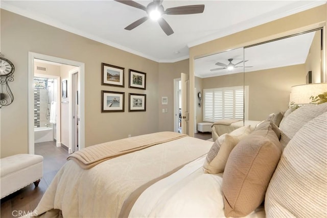 bedroom with ensuite bath, a ceiling fan, a closet, and ornamental molding