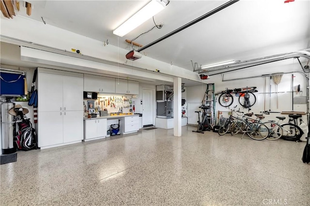 garage with a workshop area and a garage door opener