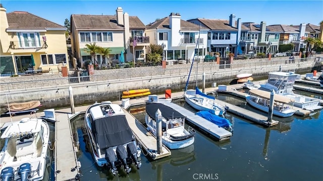 view of dock with a residential view and a water view