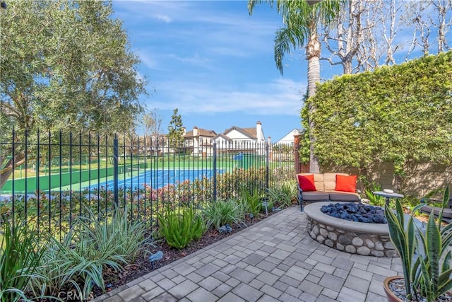 view of patio with fence and a fire pit