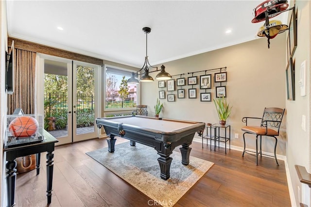 game room with crown molding, billiards, wood finished floors, and baseboards