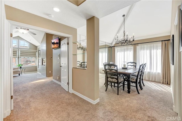 dining room featuring vaulted ceiling, carpet flooring, ceiling fan with notable chandelier, and baseboards