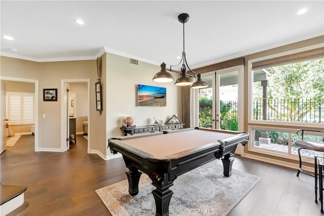 game room featuring dark wood-style floors, visible vents, baseboards, and ornamental molding