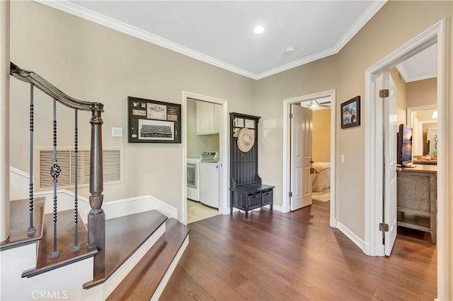 foyer entrance with independent washer and dryer, ornamental molding, wood finished floors, stairway, and baseboards