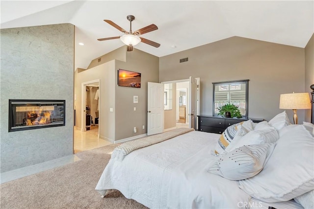 bedroom with baseboards, visible vents, ceiling fan, a tiled fireplace, and light colored carpet