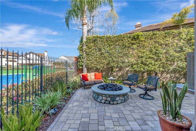 view of patio with a fire pit and fence