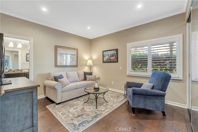 living area with crown molding, dark wood-type flooring, and baseboards