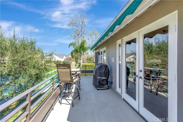 view of patio featuring french doors, a balcony, and grilling area