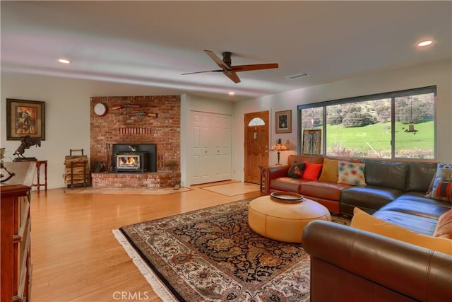 living room with a ceiling fan, wood finished floors, recessed lighting, and visible vents