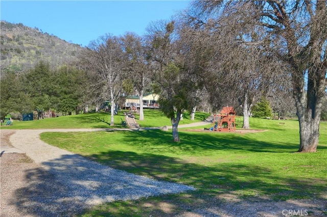 surrounding community featuring playground community and a yard