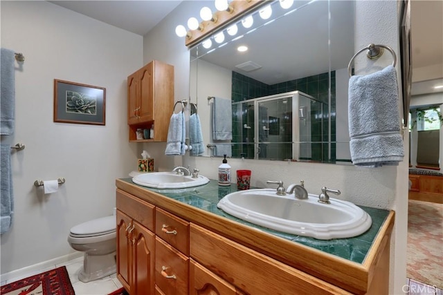 full bath with a shower stall, toilet, double vanity, and a sink