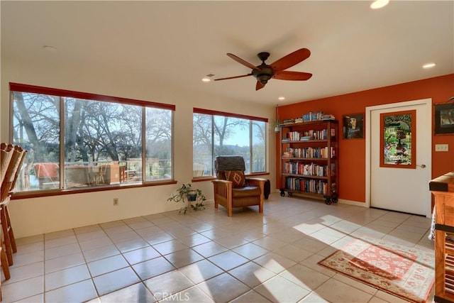 living area with light tile patterned floors, recessed lighting, and a ceiling fan