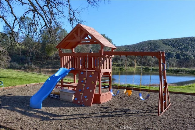 view of playground with a water view