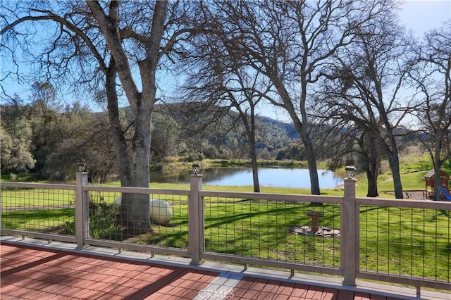 deck featuring a lawn and a water view