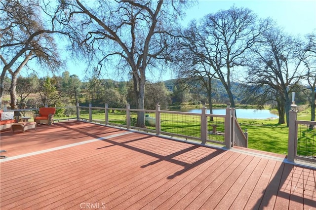 deck featuring a yard and a water view