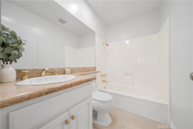 bathroom featuring tile patterned floors, visible vents, toilet, bathing tub / shower combination, and vanity