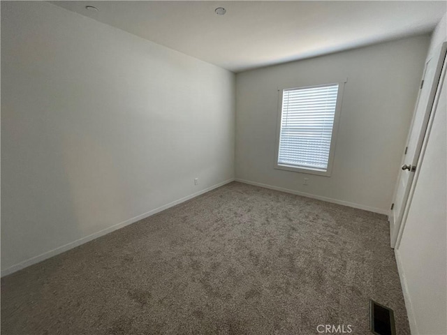 unfurnished bedroom featuring visible vents, baseboards, and carpet