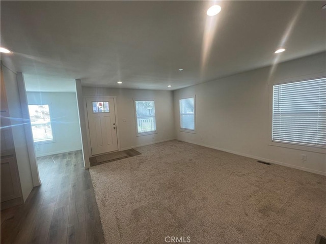 interior space with recessed lighting, visible vents, baseboards, and a healthy amount of sunlight