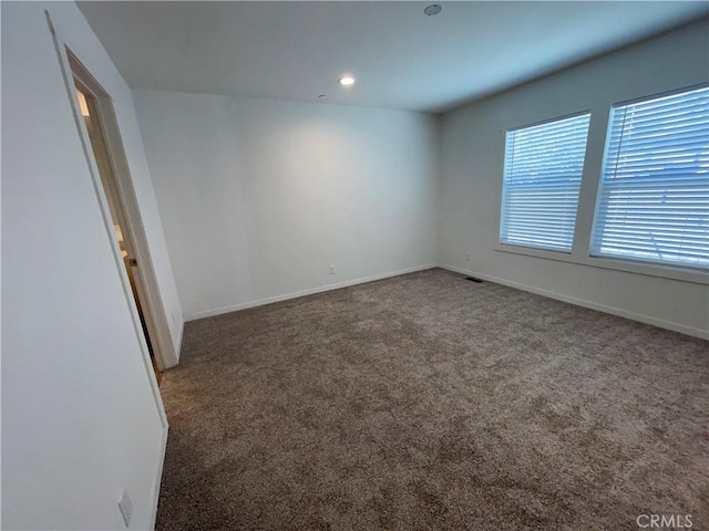 spare room with carpet flooring, recessed lighting, and baseboards