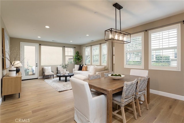 dining area with recessed lighting, light wood-type flooring, and baseboards