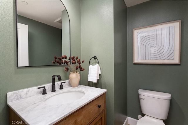 bathroom with toilet and vanity