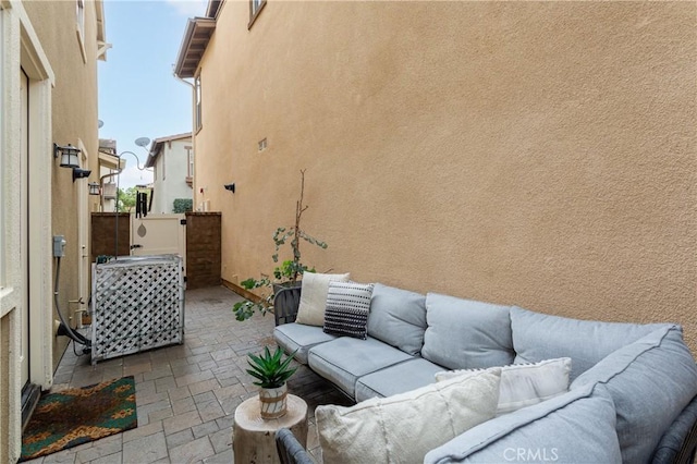 view of patio with an outdoor living space and fence