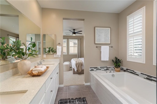 bathroom featuring double vanity, a garden tub, tile patterned floors, and a sink