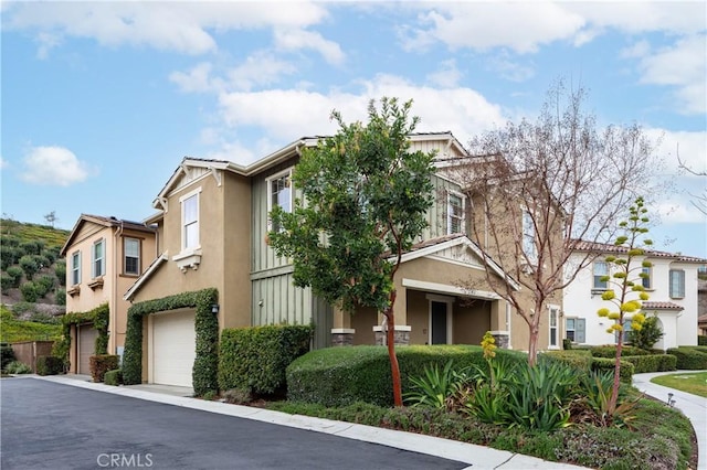 multi unit property featuring stucco siding and an attached garage