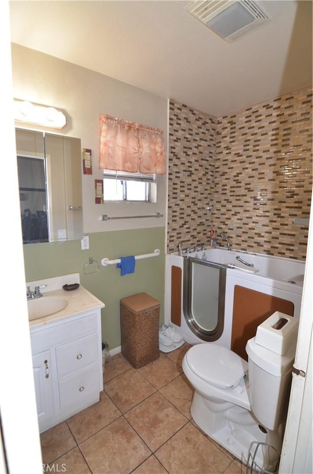 bathroom with tile patterned floors, visible vents, toilet, and vanity