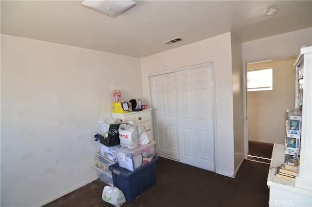 bedroom with baseboards, visible vents, and a closet