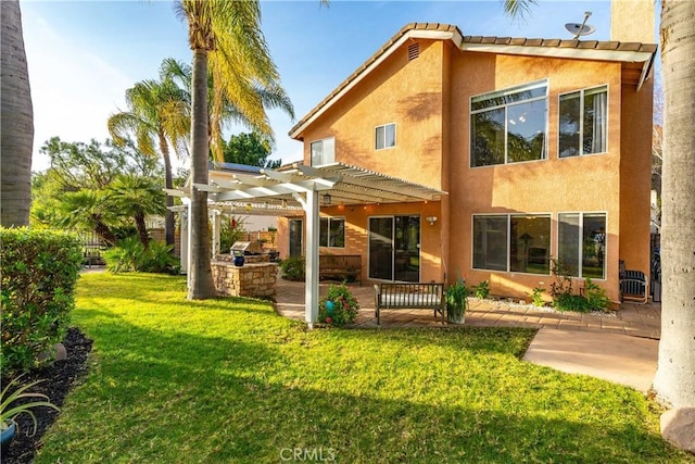 rear view of house featuring a lawn, a patio area, a pergola, and stucco siding