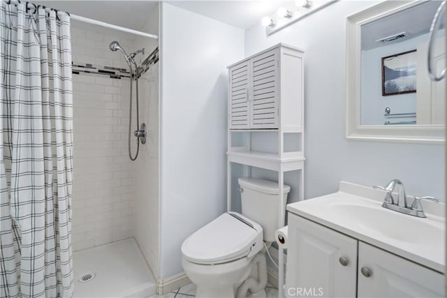 bathroom featuring visible vents, toilet, a stall shower, and vanity