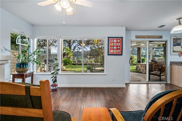 dining space with visible vents, wood finished floors, baseboards, and ceiling fan