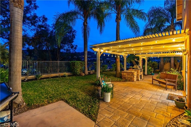 view of patio / terrace featuring fence, an outdoor kitchen, and a pergola