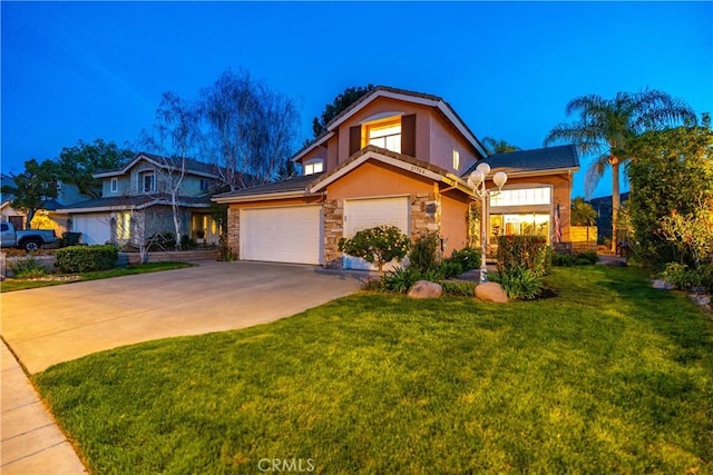 traditional home with driveway, stucco siding, a front lawn, a garage, and stone siding