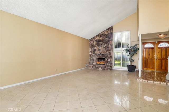 unfurnished living room featuring light tile patterned floors, a fireplace, high vaulted ceiling, and baseboards